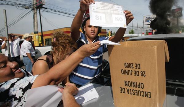 Honduran citizens cast their votes in defiance of a military coup that ousted Honduran President Manuel Zelaya and cancelled planned elections. Photo by Oswaldo Rivas/Reuters.