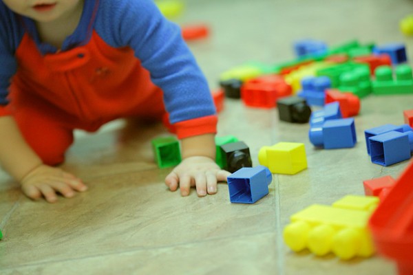 Toddler with blocks in disarray