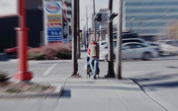 Man pushing shopping cart in Calgary. Creative Commons photo by Flickr User C Law.